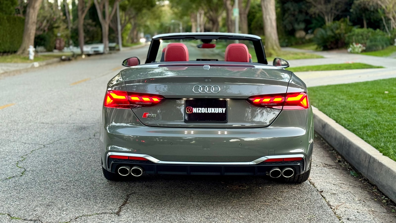 Rear of the grey Audi S5 Cabriolet with red seats visible