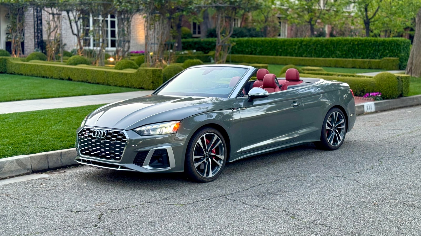 Grey Audi S5 Cabriolet from a front three-quarter with the roof down