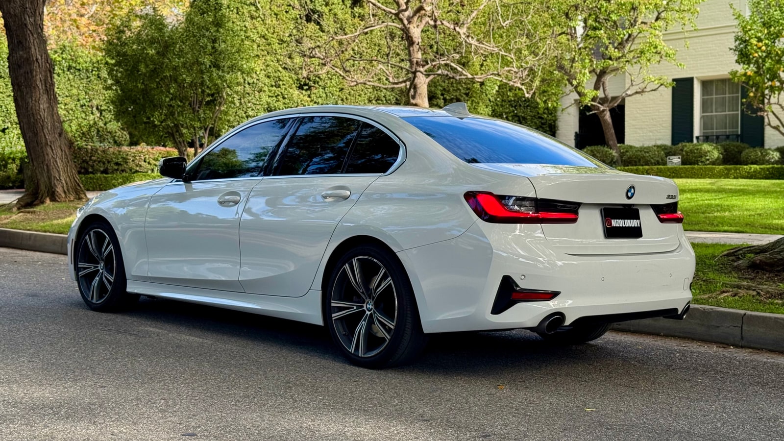 White BMW 3 Series from the rear three-quarter