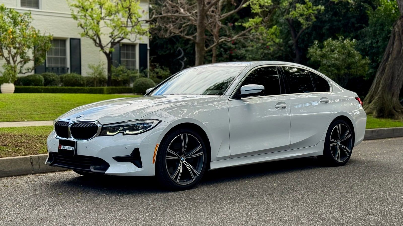 White BMW 3 Series saloon on a Los Angeles street, front three-quarter view