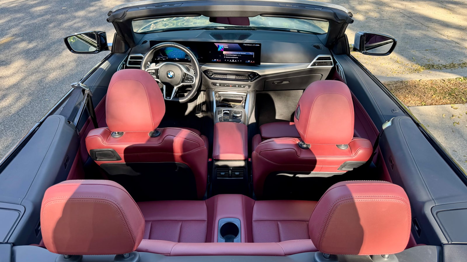 Red leather cabin of the BMW 430i Convertible seen from above with the roof down