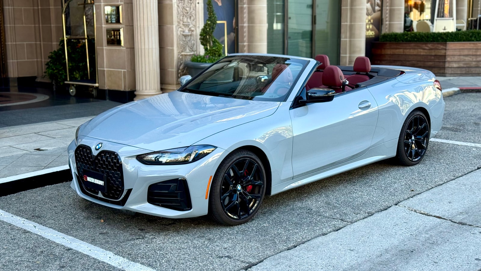 Grey BMW 430i Convertible in profile with the roof down