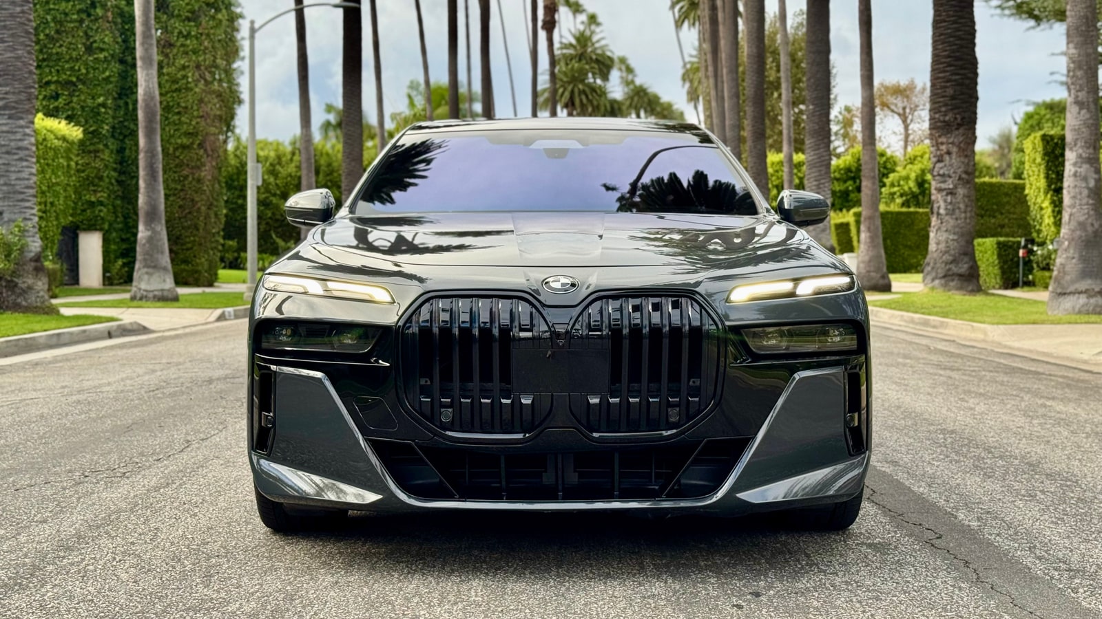Grey BMW 760i head-on with its large kidney grille and split headlamps