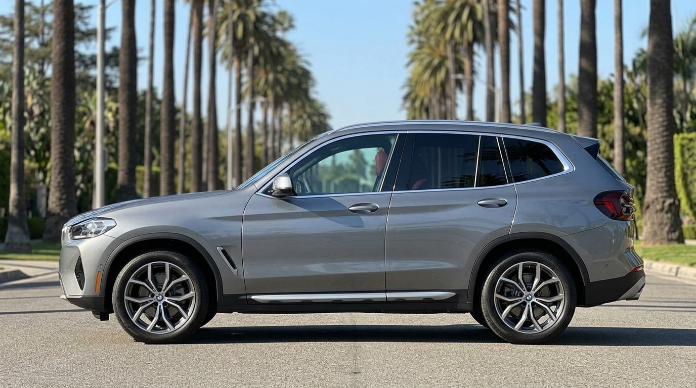 Grey BMW X3 in profile on a palm-lined Beverly Hills street