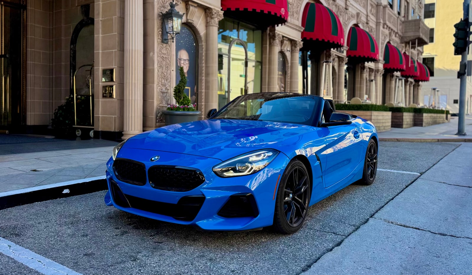 Blue BMW Z4 from a front three-quarter with the roof down