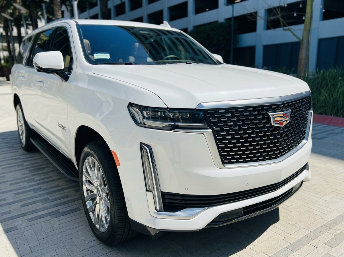 Chrome grille and vertical headlamp blade of the white Cadillac Escalade ESV