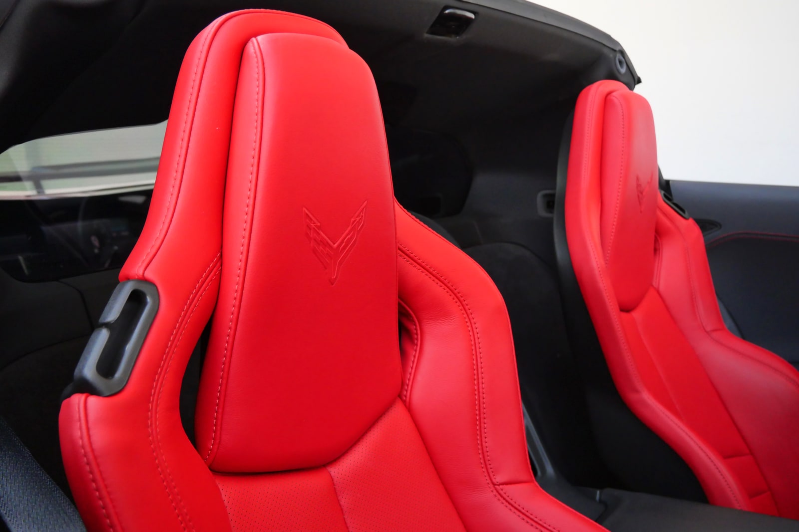 Two red leather seats of the Chevrolet Corvette with the roof removed