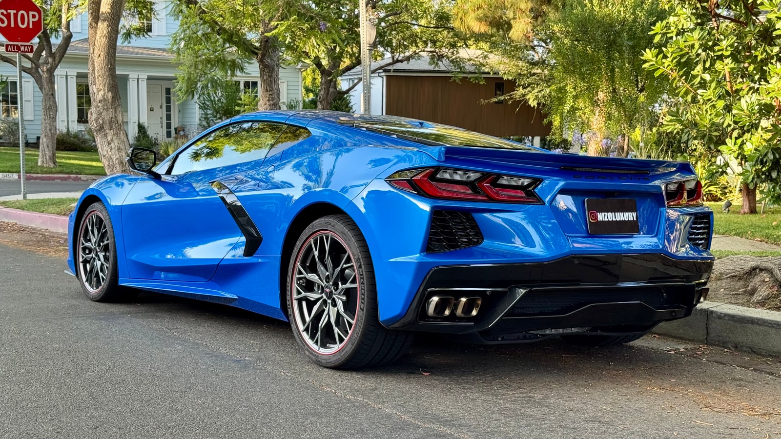 Rear three-quarter of the blue Chevrolet Corvette showing the vents behind the doors
