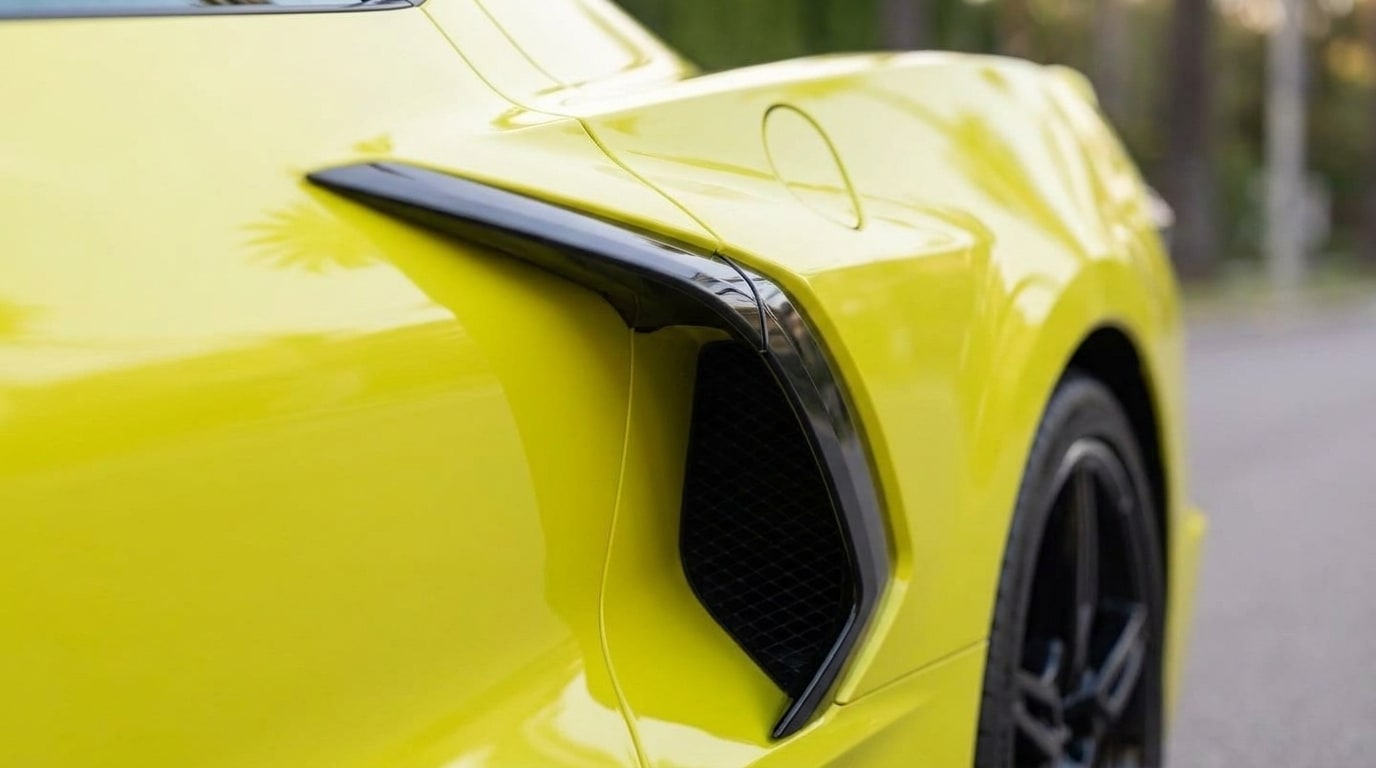 Side intake behind the door of the yellow Chevrolet Corvette