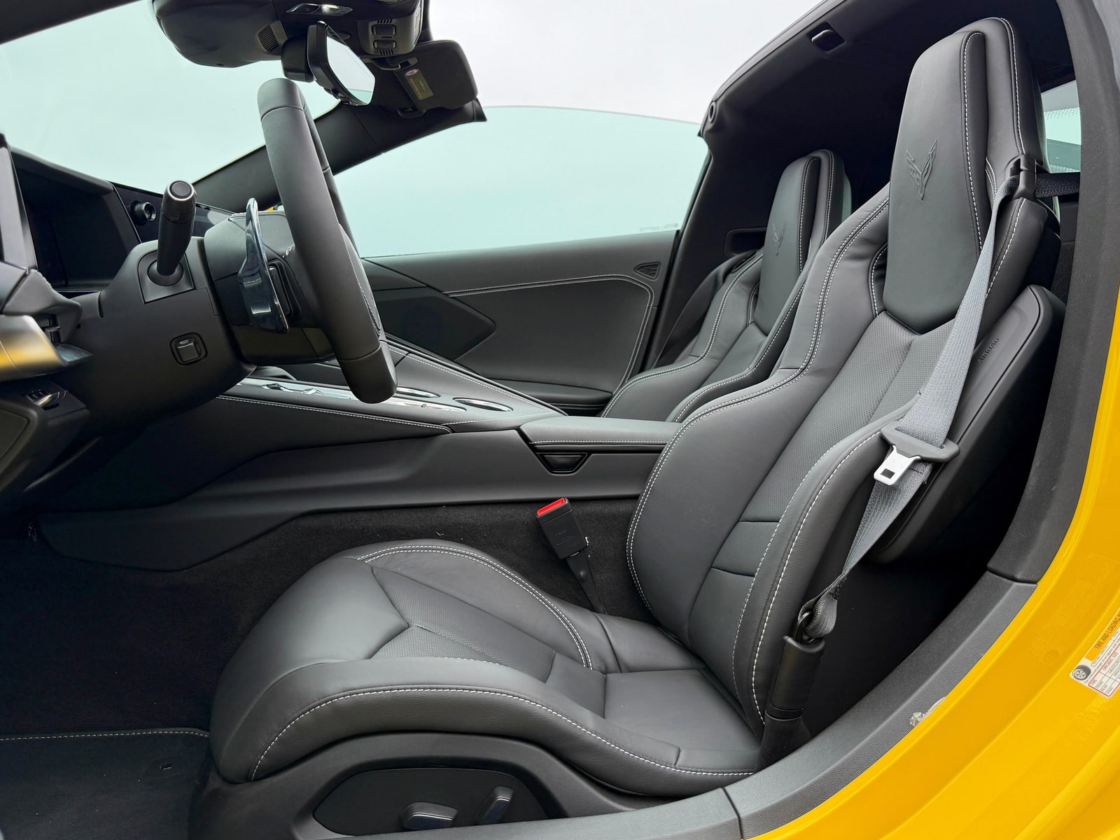 Grey leather driver seat of the Chevrolet Corvette C8 seen through the open door