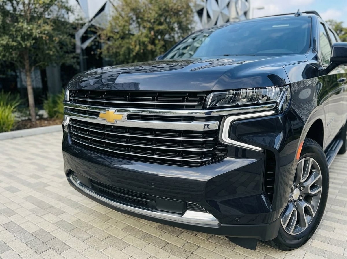 Chrome grille bar and headlamp of the black Chevrolet Suburban