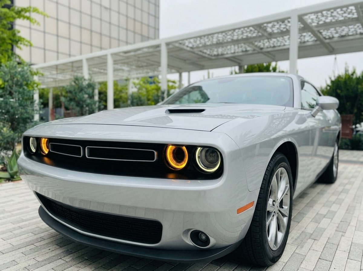Split grille and round headlamp of the white Dodge Challenger