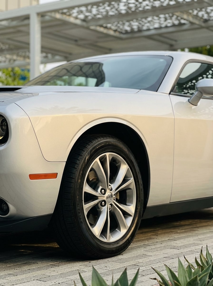 Front wheel and squared arch of the white Dodge Challenger