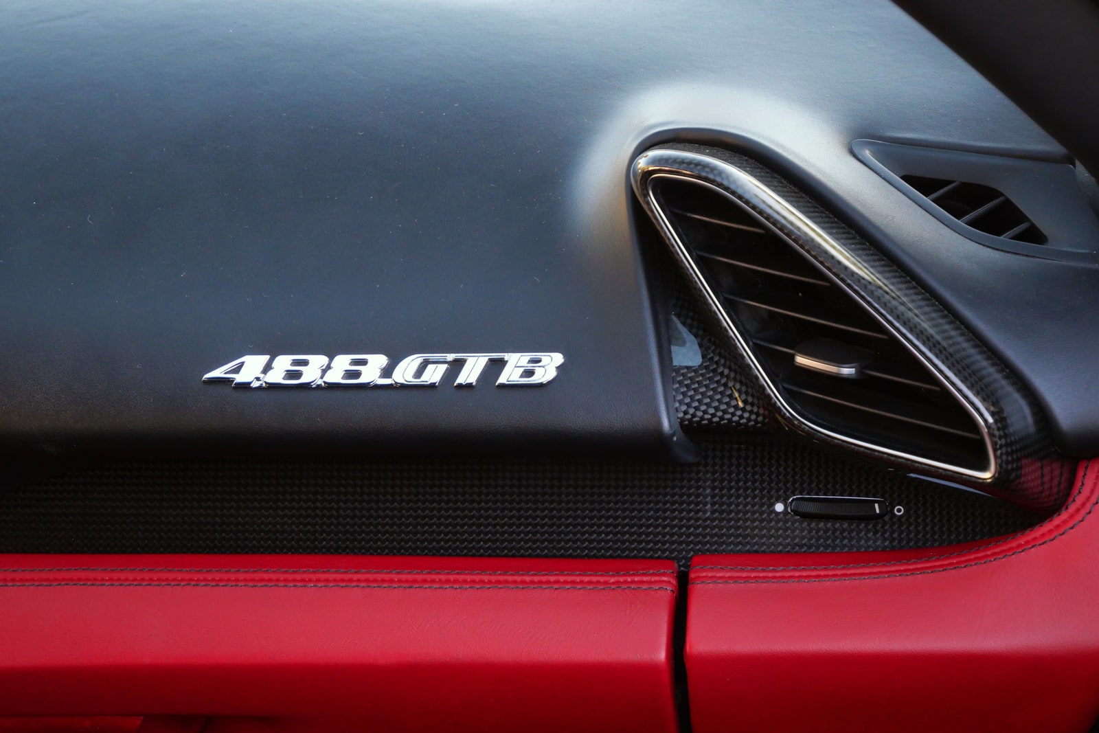 488 GTB badge on the dashboard of the Ferrari