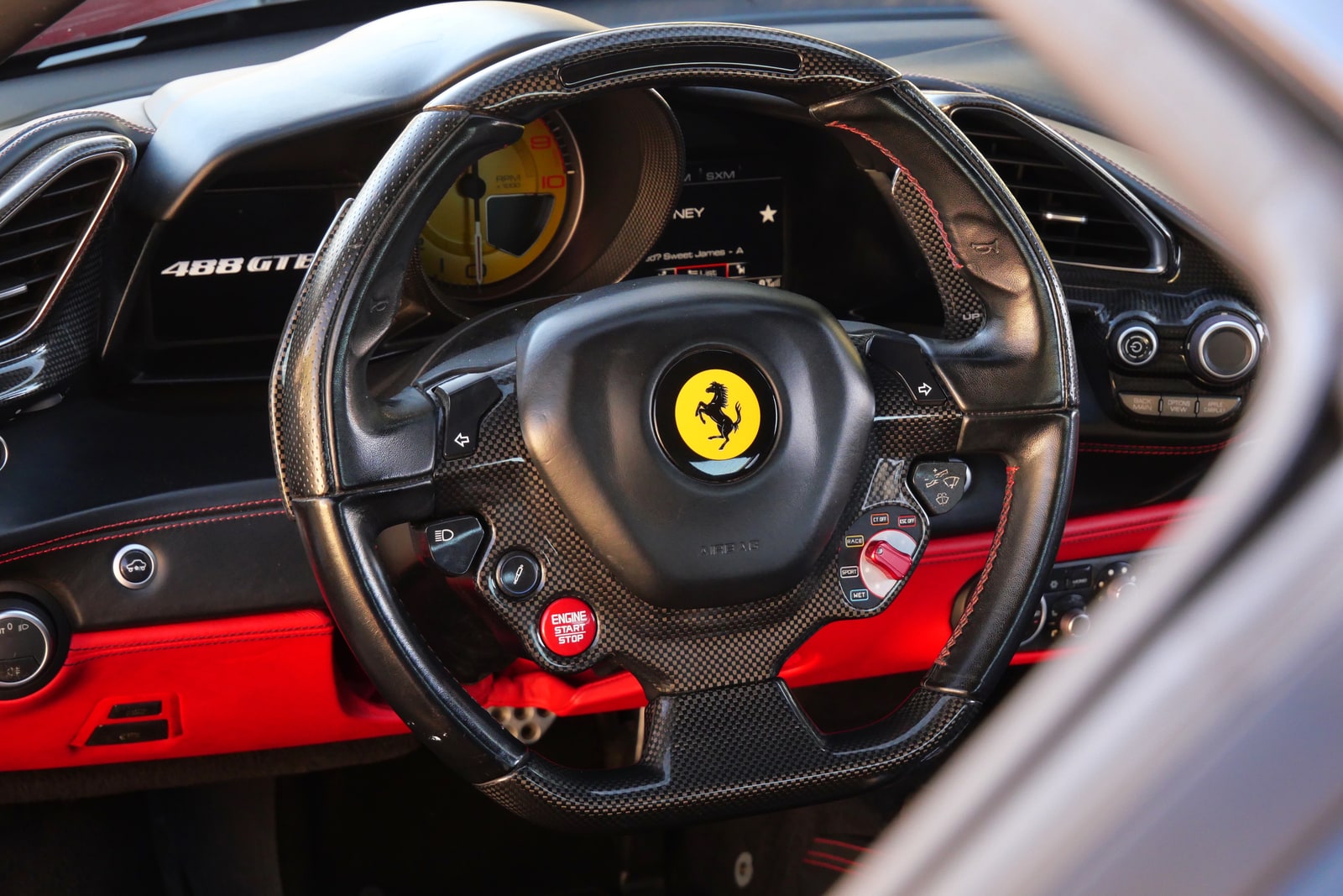 Steering wheel of the Ferrari 488 GTB with the prancing horse and manettino dial