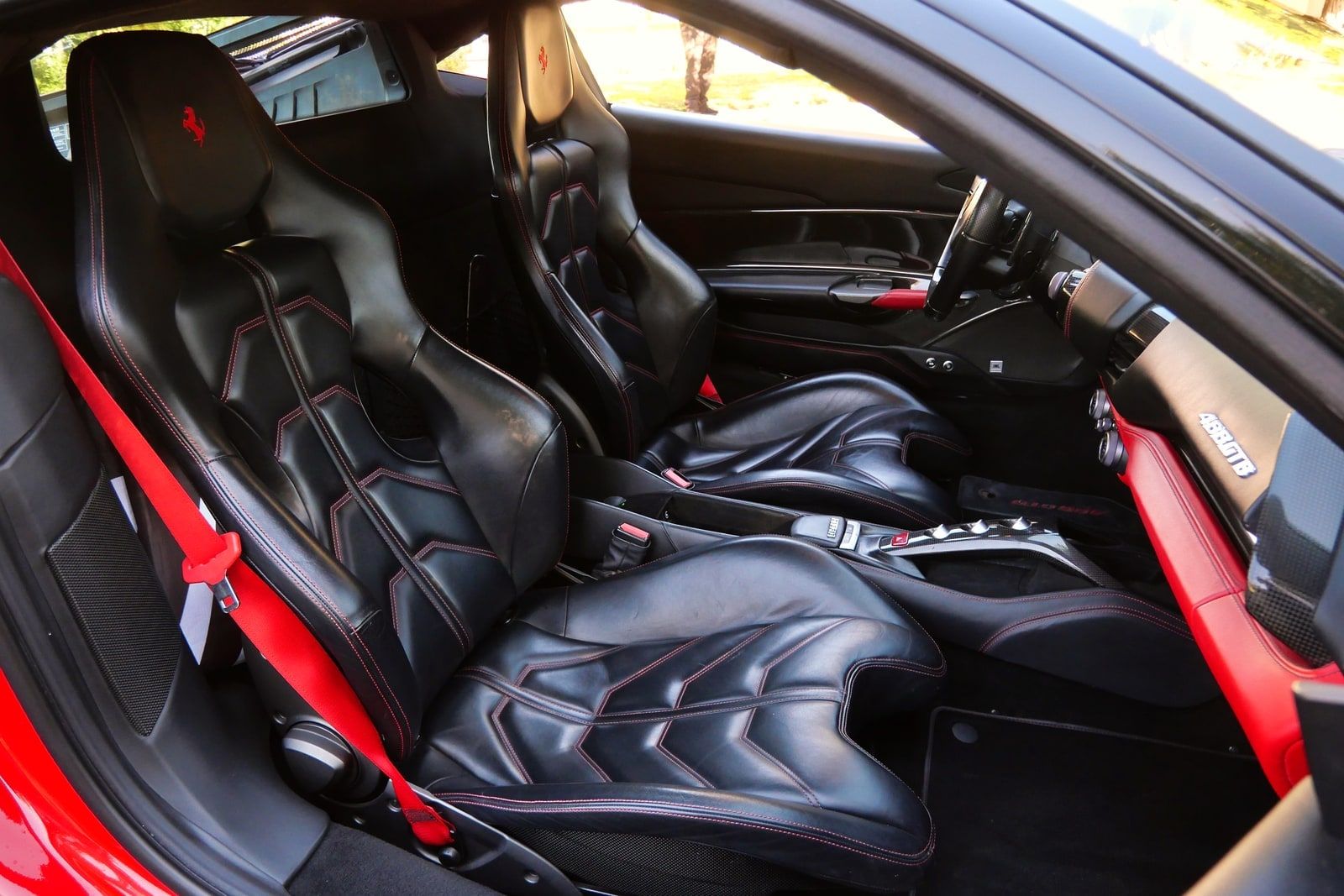 Red Ferrari 488 GTB from the side showing the scalloped air intake behind the door