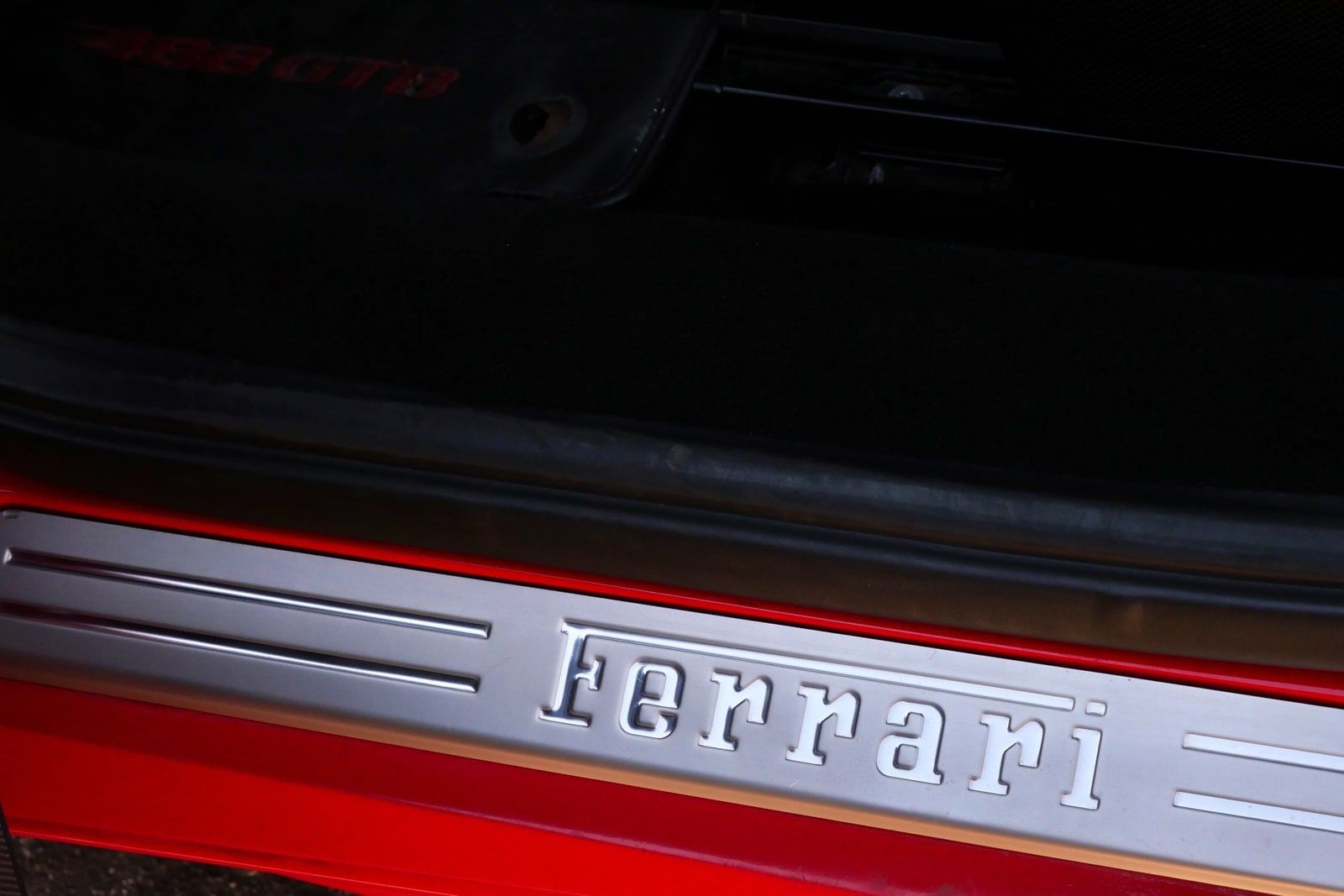 Red Ferrari 488 GTB parked on a Los Angeles street, rear three-quarter view