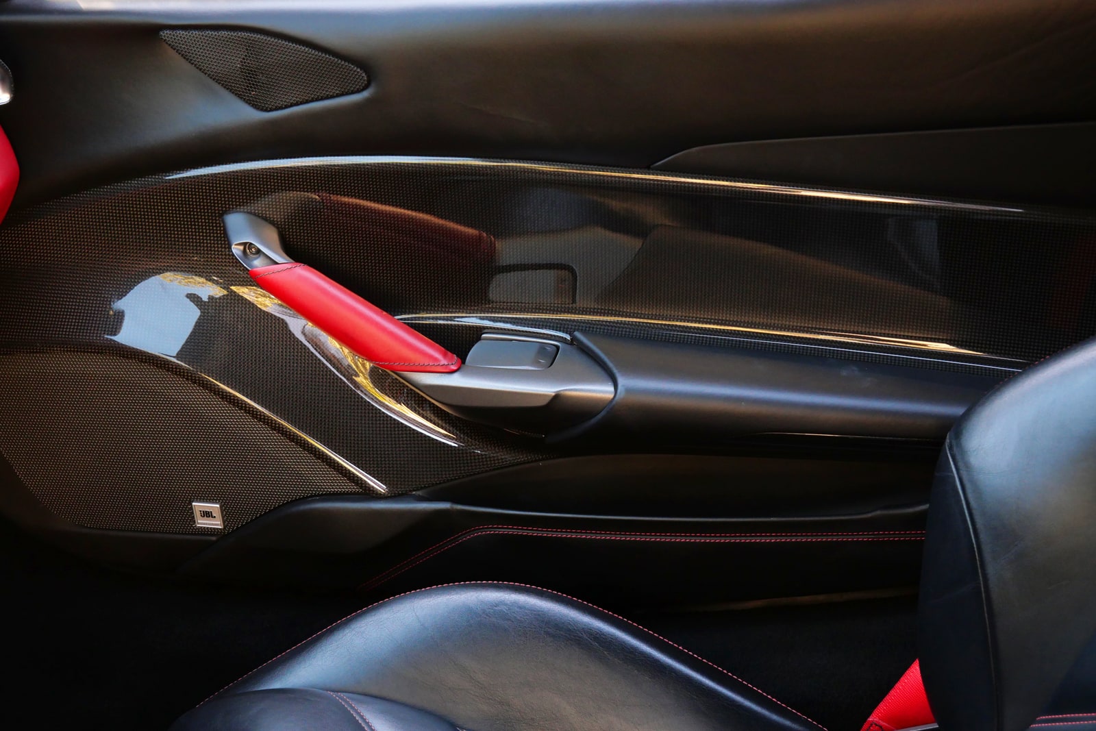 Carbon fibre centre tunnel of the Ferrari 488 with the red launch lever