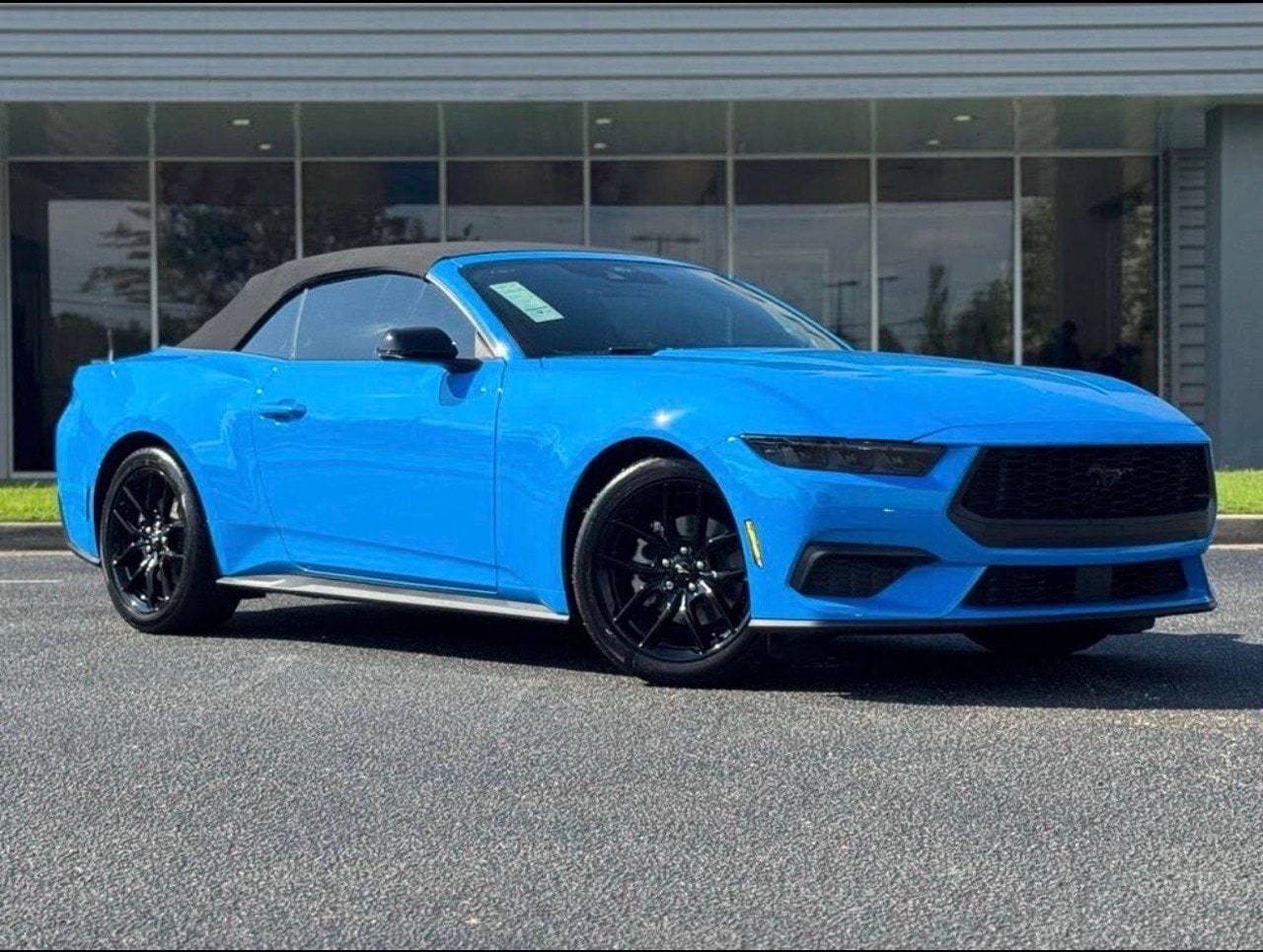Blue Ford Mustang Convertible with the roof raised