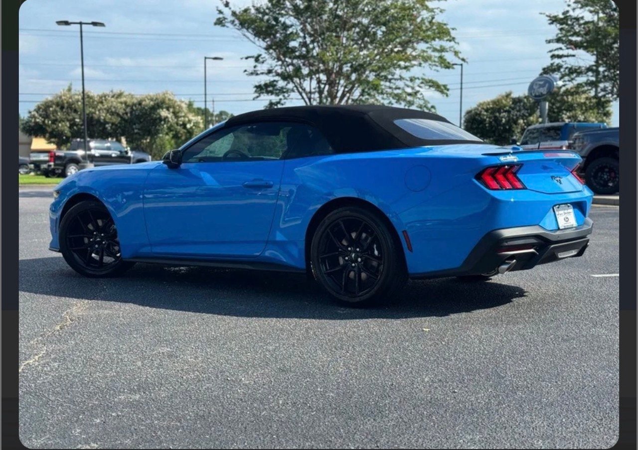 Blue Ford Mustang Convertible from the rear three-quarter