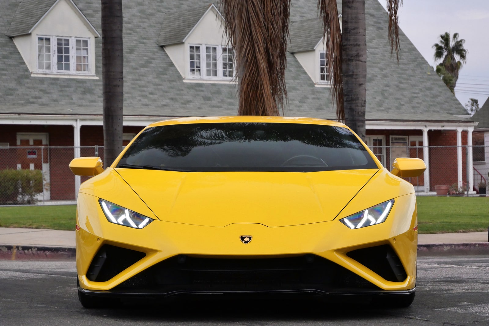 Yellow Lamborghini Huracán Evo seen head-on with the crest centred on the nose