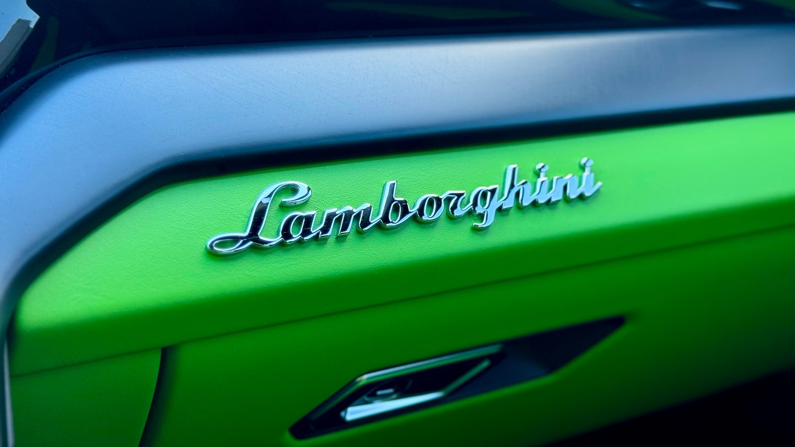 Lamborghini script embossed into the green door card of the Urus