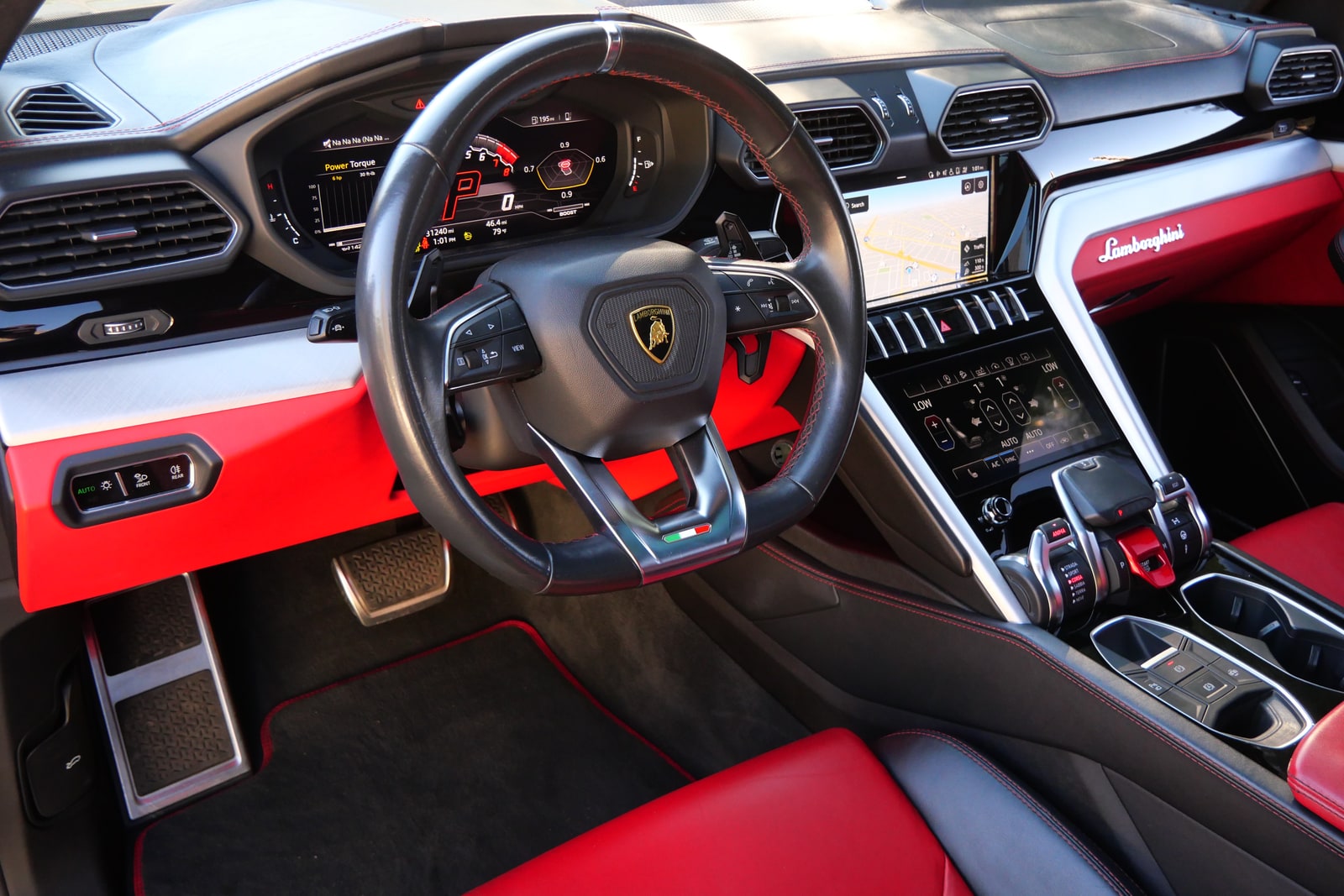 Steering wheel and red dashboard of the black Lamborghini Urus