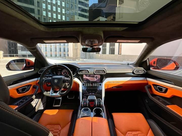 Orange and black cabin of an orange Lamborghini Urus