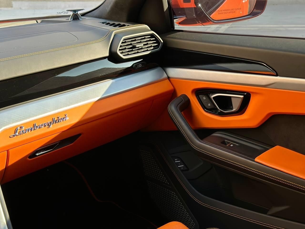 Orange leather door card with Lamborghini script in the Urus