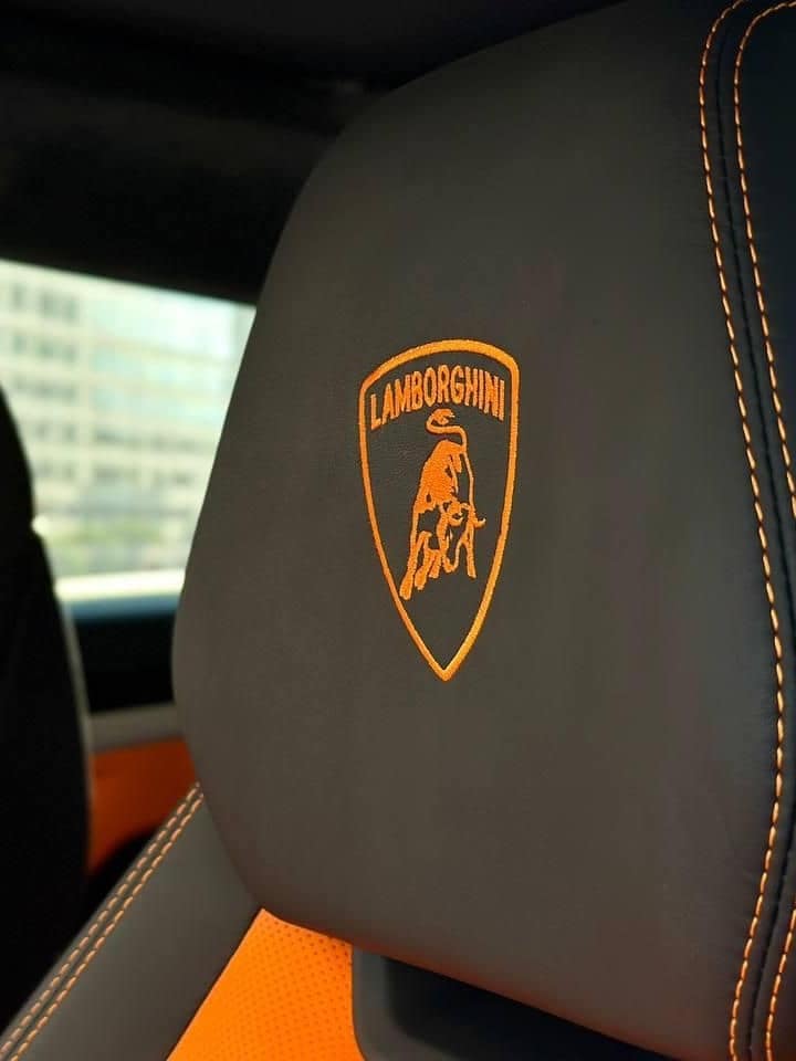 Orange bull stitched into a Lamborghini Urus headrest