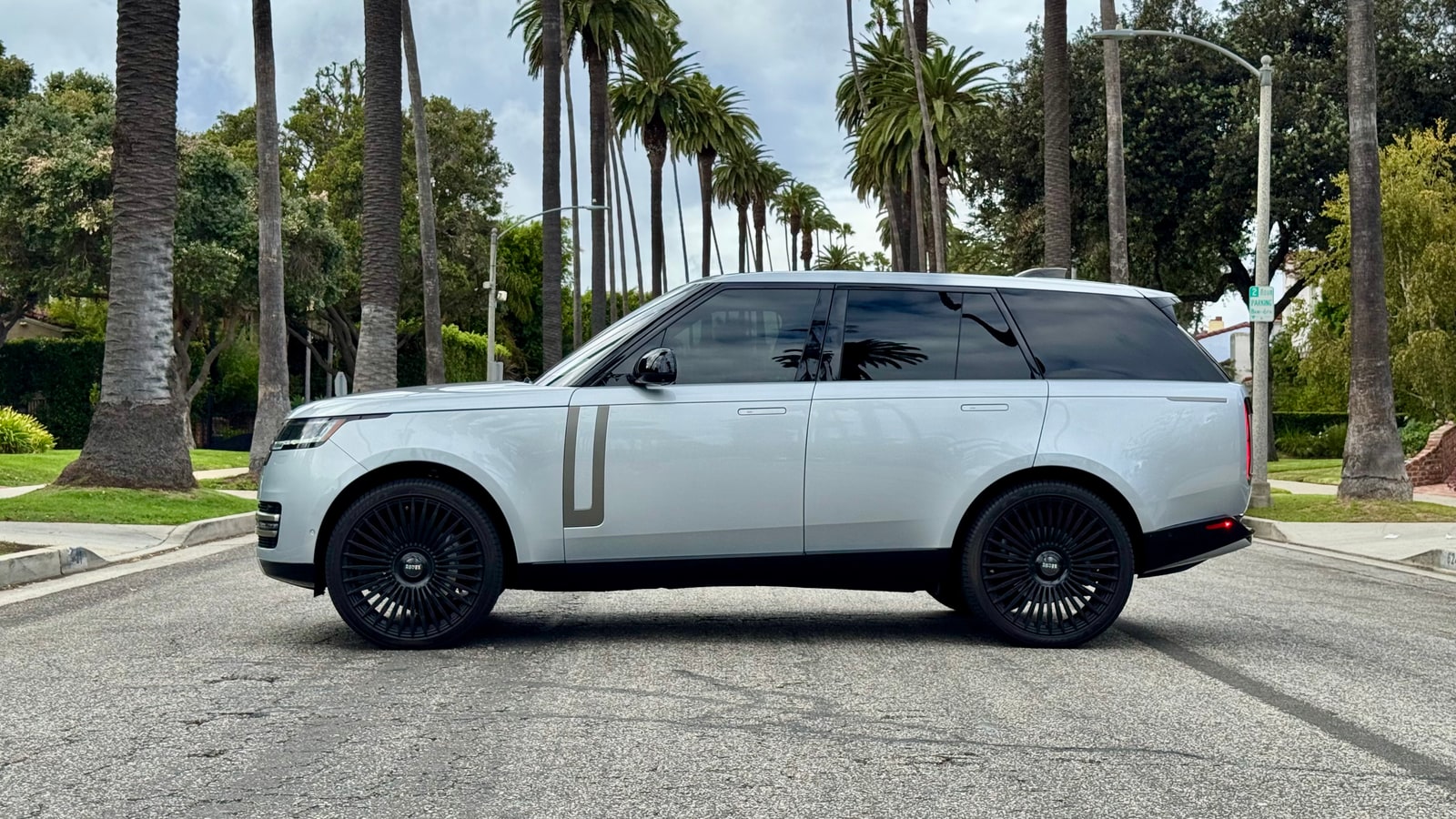 Silver full-size Range Rover in profile with black wheels