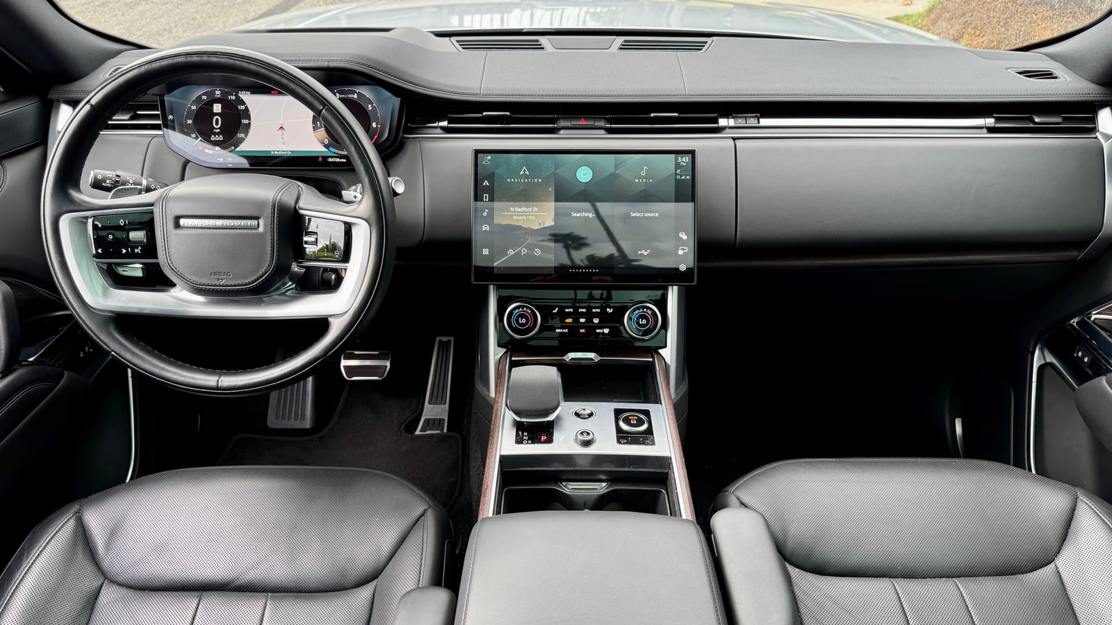 Dashboard of the Range Rover with central touchscreen and wood trim