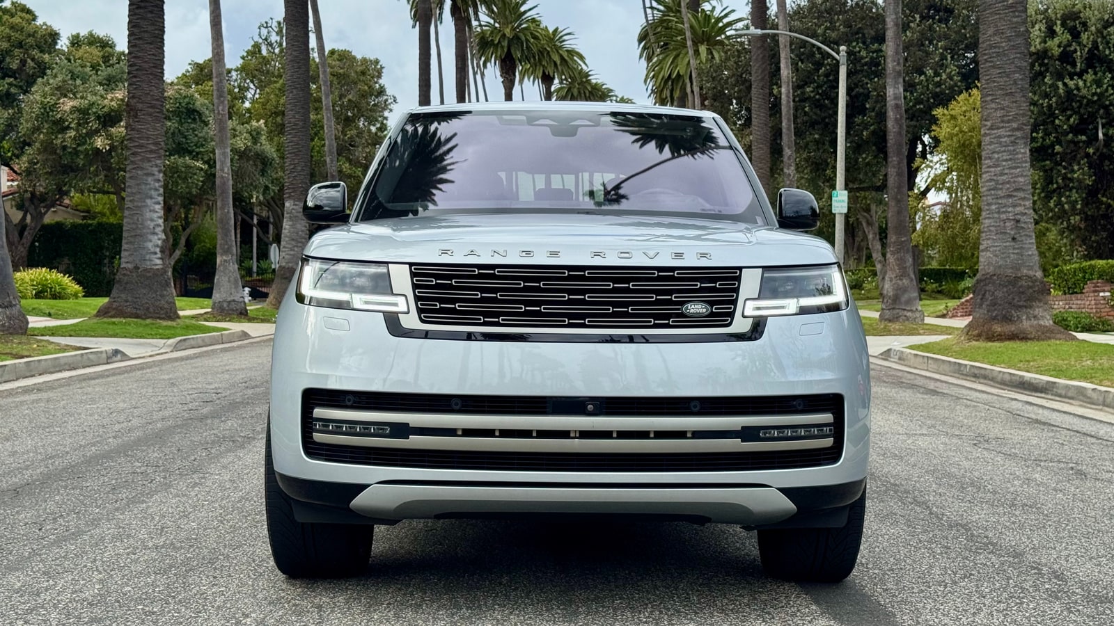 Silver Range Rover head-on with its grille and slim headlamps