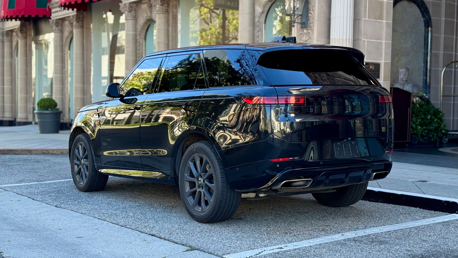 Rear three-quarter of the black Range Rover Sport on a Beverly Hills street