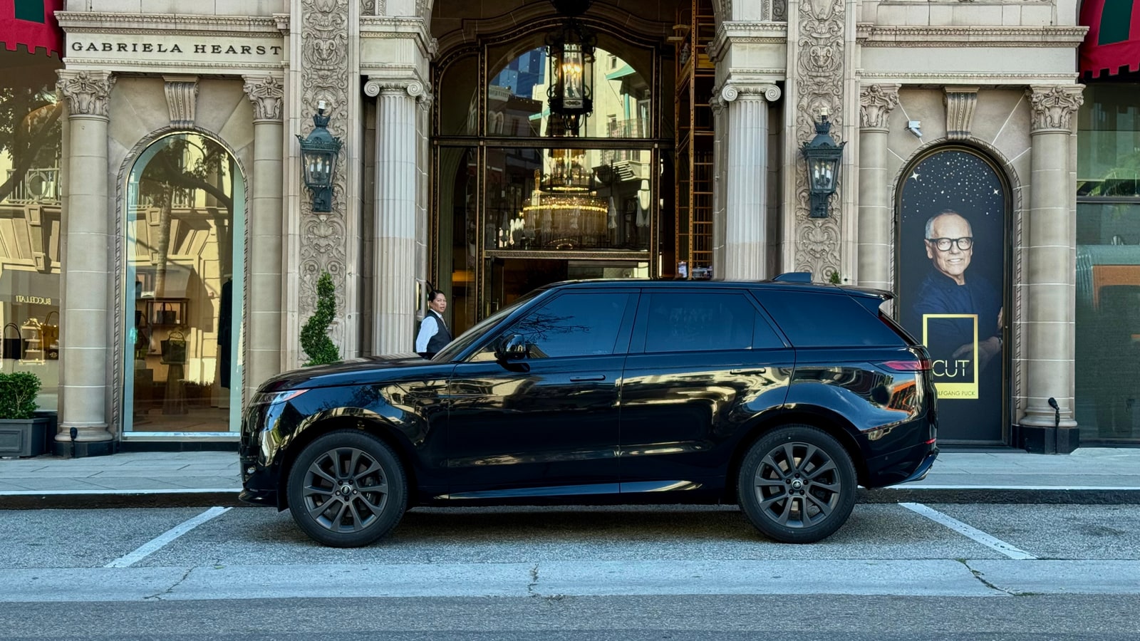 Black Range Rover Sport in profile outside a Beverly Hills boutique
