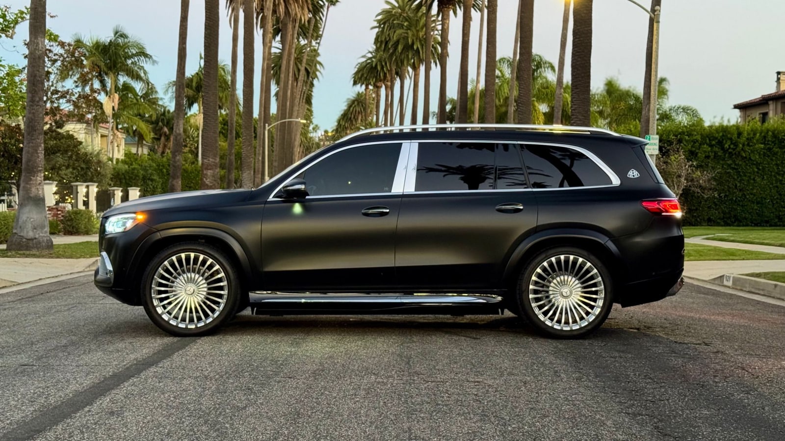 Matte black Maybach GLS 600 in profile, showing its full length and chrome running boards