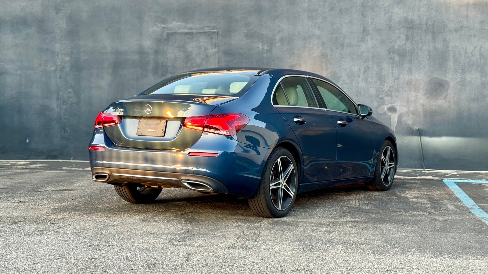 Blue Mercedes A220 from the rear three-quarter