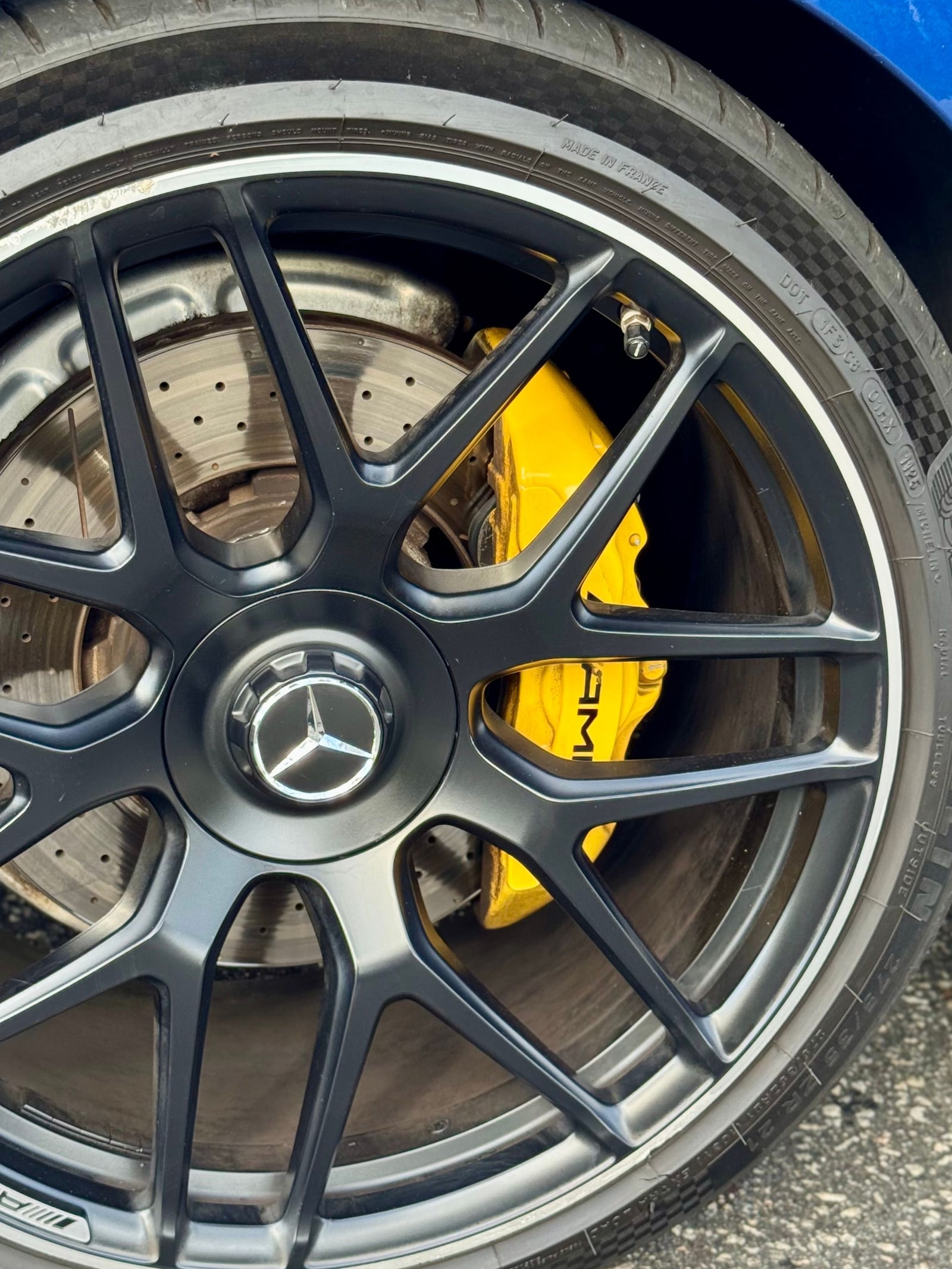 Black forged wheel and yellow brake caliper on the blue Mercedes-AMG GT 53