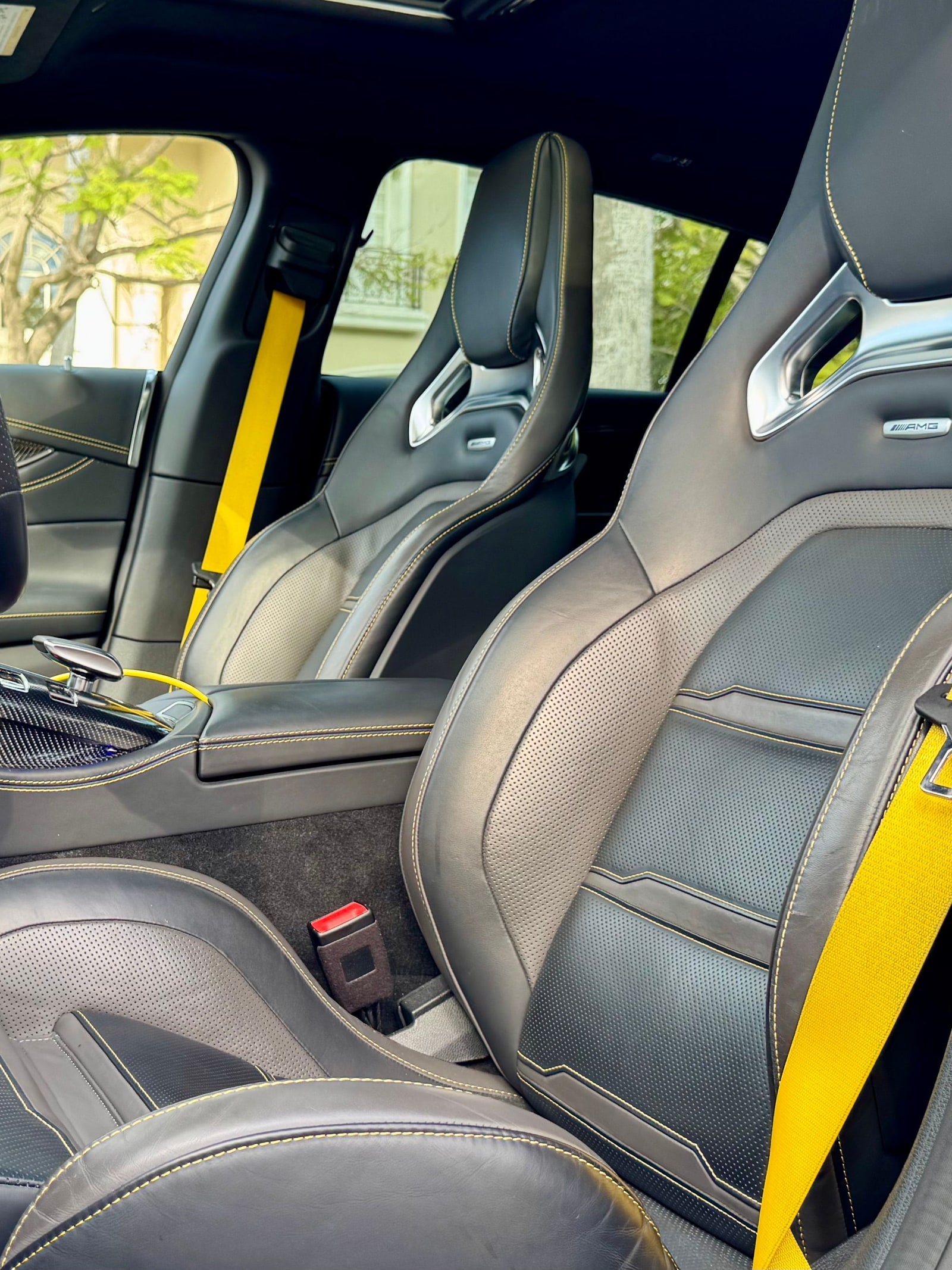 AMG sport front seat with a yellow seat belt in the Mercedes-AMG GT 53