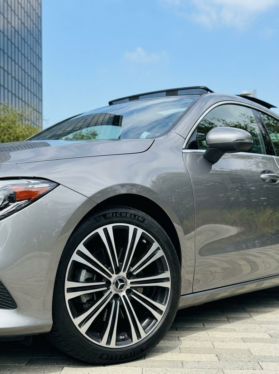 Front wheel and roofline of the silver Mercedes CLA 250