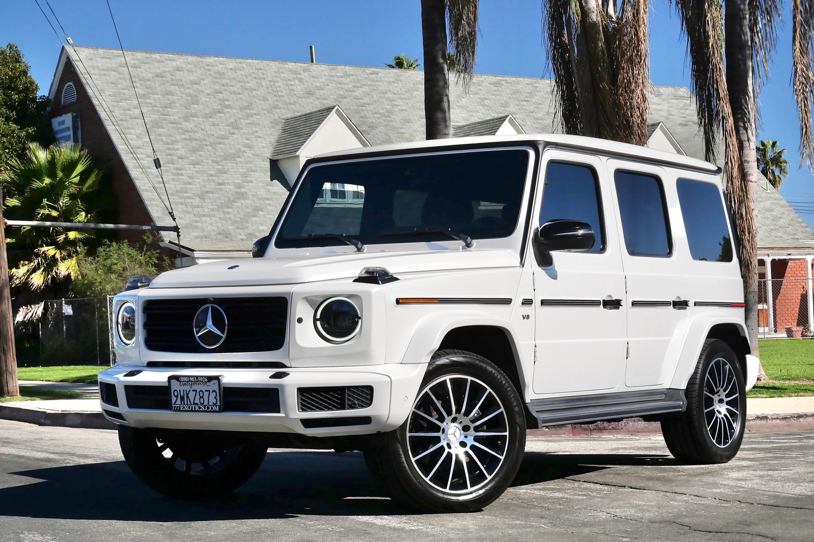 White Mercedes-Benz G 550 from a front three-quarter with the V8 badge on the wing