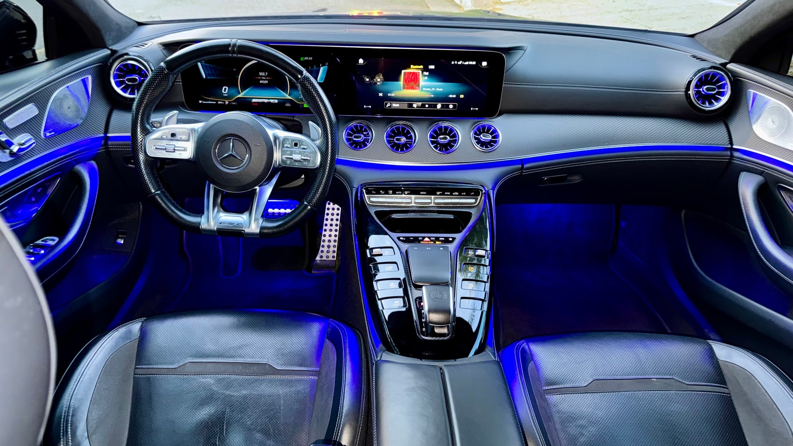Cabin of the Mercedes-AMG GT 43 lit in blue ambient light