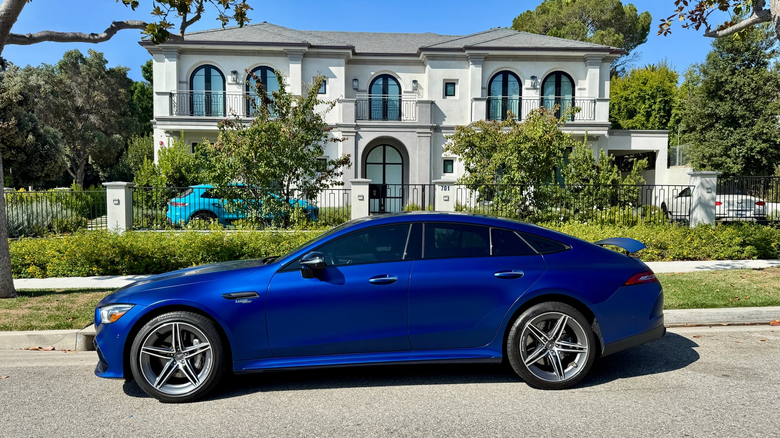 Blue Mercedes-AMG GT 43 in profile outside a Beverly Hills house