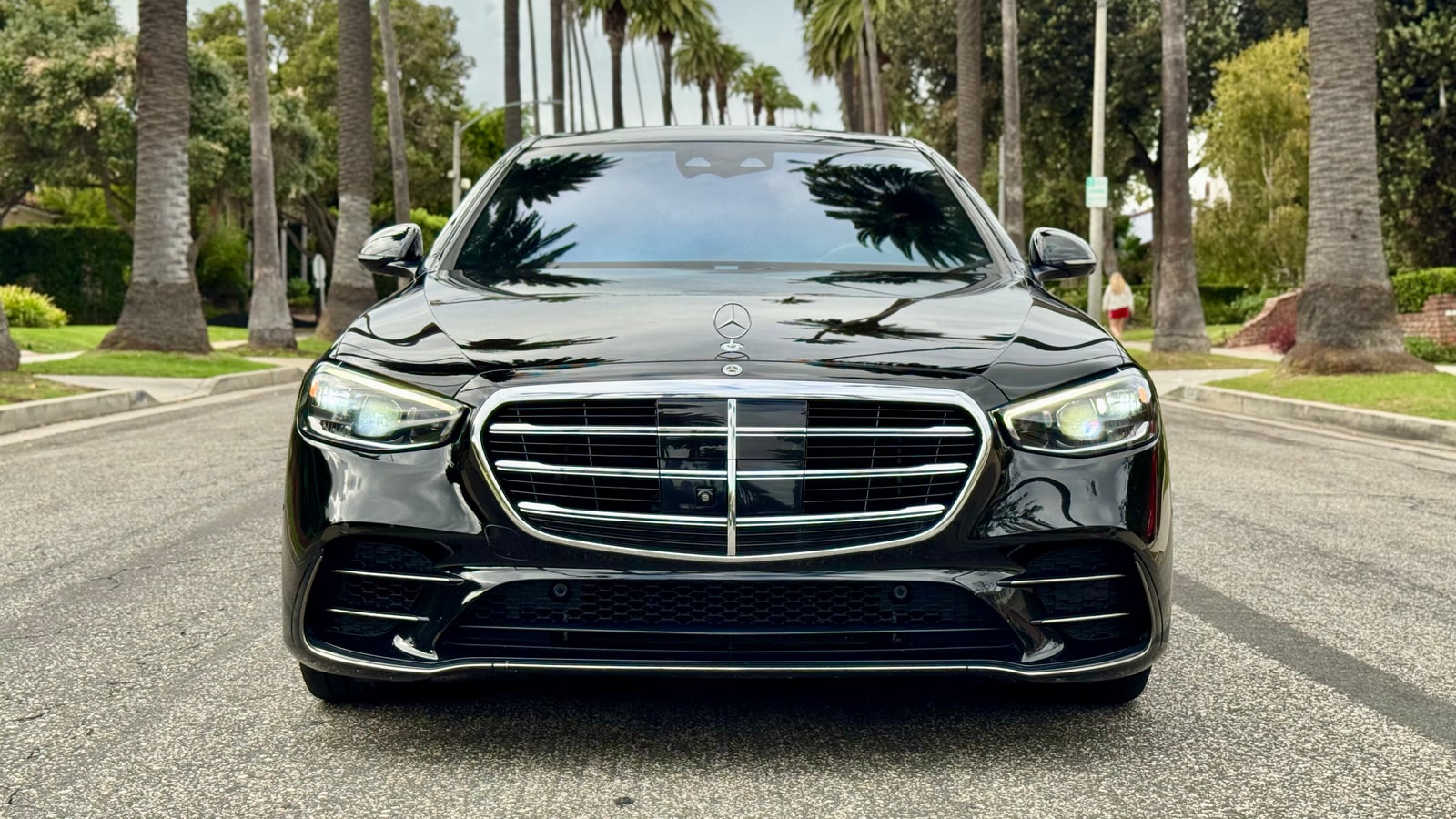 Black Mercedes S 580 head-on, showing the chrome grille and headlamps