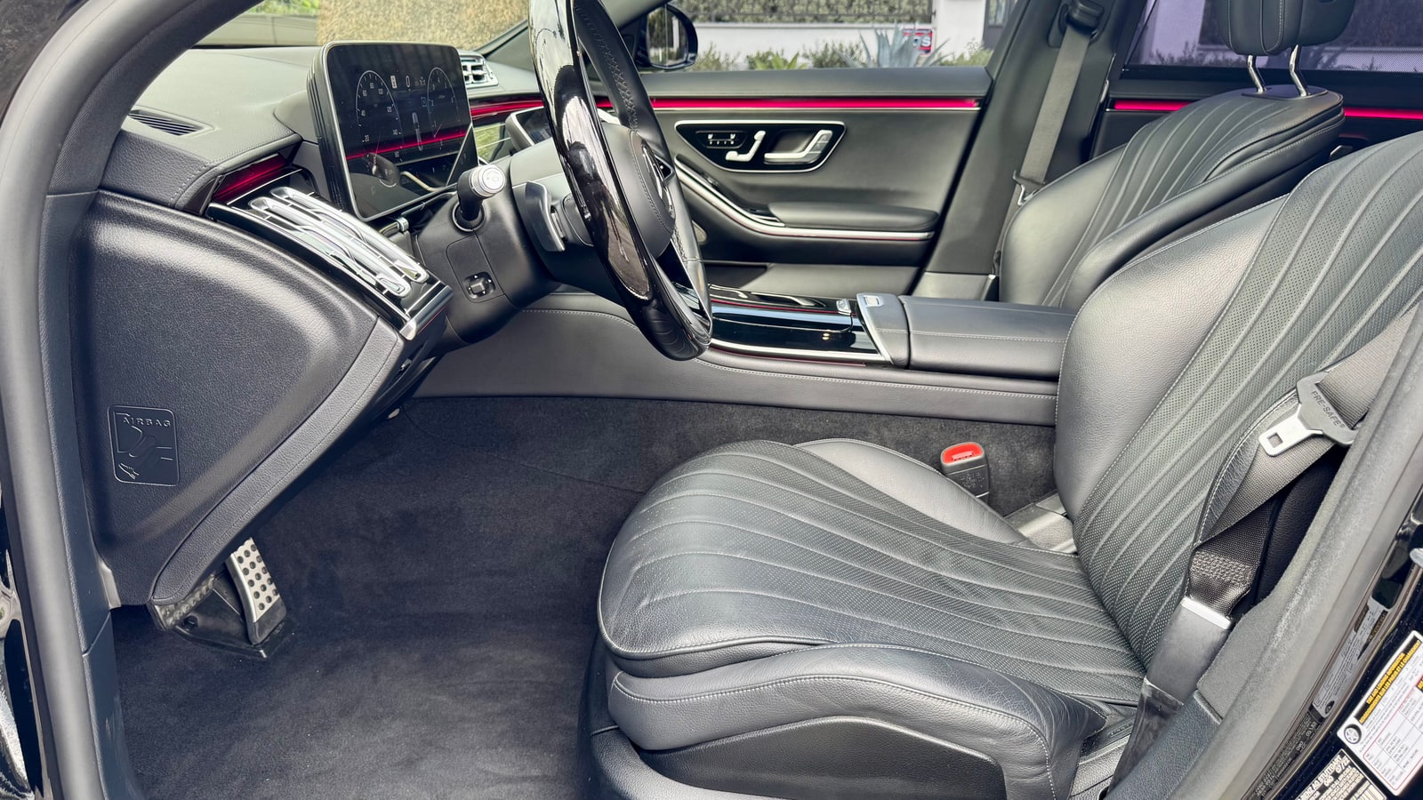 Black leather front and rear seats of the Mercedes S 580 seen through the open door