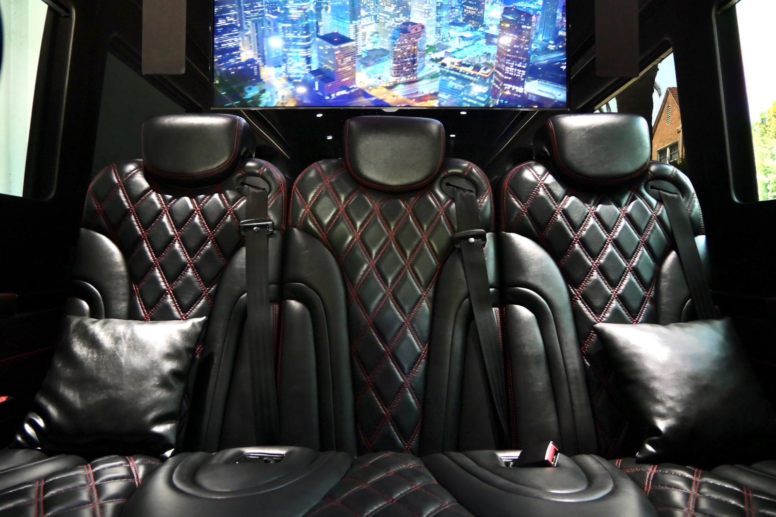 Rows of quilted captain's chairs in the Mercedes Sprinter cabin