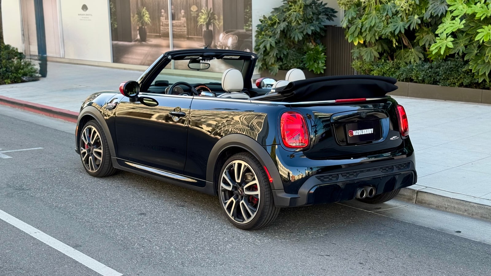 Black Mini Cooper Convertible from the rear three-quarter