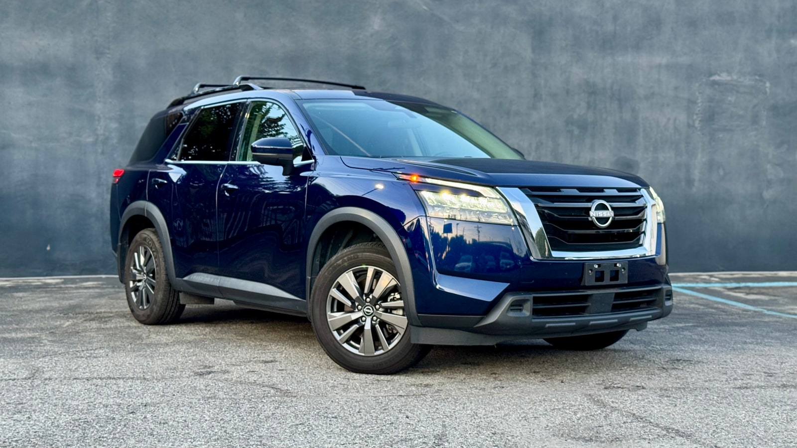 Blue Nissan Pathfinder from a front three-quarter
