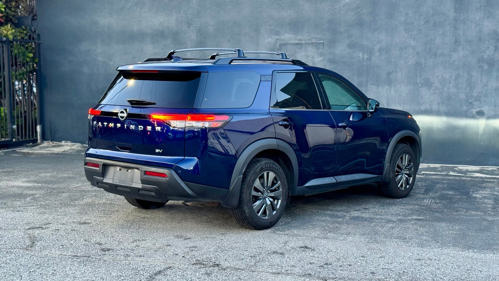 Blue Nissan Pathfinder from the rear three-quarter
