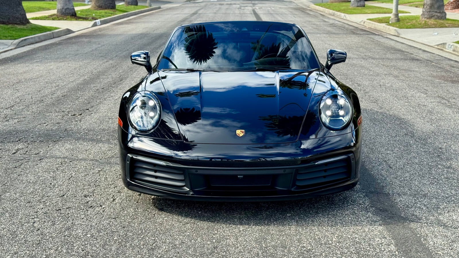 Black Porsche 911 head-on with round headlamps